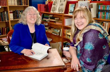 Bronwyn seated and signing a book for a friend